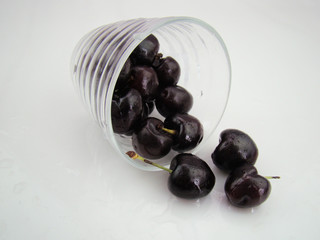 The cherries inside the glass are scattered and poured out