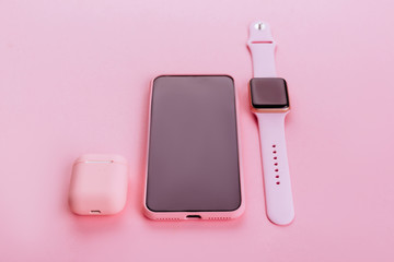 Up to date technology.Top view of diverse personal accessory laying on the pink background