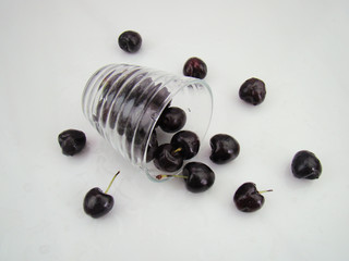 The cherries inside the glass are scattered and poured out