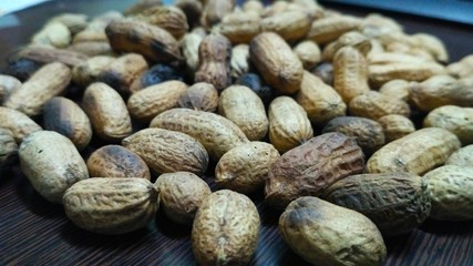 Peanuts in shell scattered in table