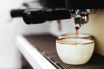 Barista making a cappuccino with a classic Italian coffee machine