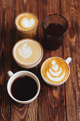 five cups of coffee on vintage wood. Top view , cup on wooden table. View from top