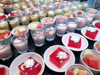 Top view of sweet red strawberry jelly topped with whip cream, chocolate mousse, strawberry...