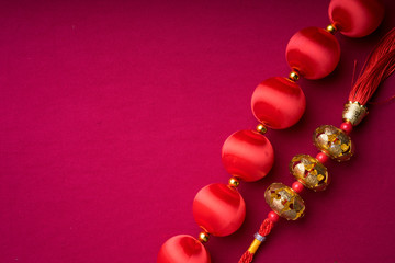 Chinese New Year decorations with red background with assorted festival decorations. Chinese characters means abundant of wealth, prosperity and luck. Flat lay.