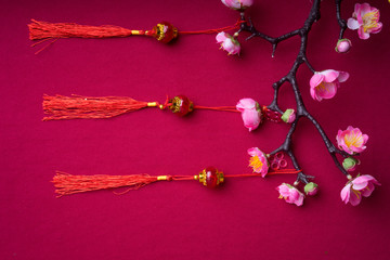 Fototapeta premium Chinese New Year decorations with red background with assorted festival decorations. Chinese characters means abundant of wealth, prosperity and luck. Flat lay.