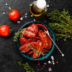 Sun dried tomatoes with fresh herbs and spices. top wiev