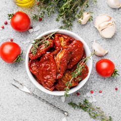 Sun dried tomatoes with fresh herbs and spices. top wiev