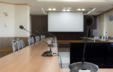 Close up microphone on brown table in meeting room