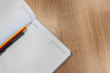 Notebooks with pencil and pen on the table