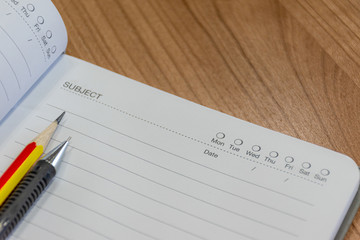 Notebooks with pencil and pen on the table