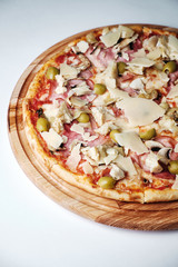 Pizza with ham, olives, mushroom and Parmesan