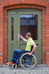 man on wheelchair entering the building