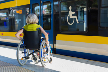 woman sitting on wheelchair on a platform - 314630860