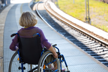 woman sitting on wheelchair on a platform