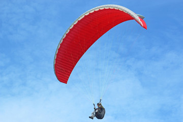 Paraglider flying wing in a blue sky	
