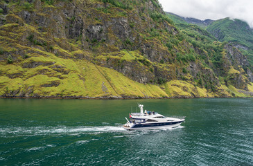 Yacht sailing in Sognefjord mountains, Norway