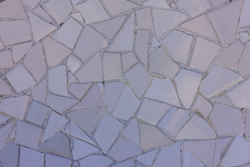 Light purple ceramic tile pattern broken glass mosaic decoration in Park Guell, Barcelona, Spain. Designed by Gaudi