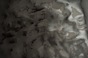 Wet black paper glued to the wall. Wet paper texture.