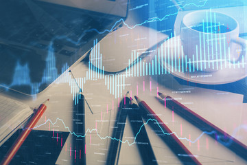 Fototapeta premium Financial graph drawing and table with computer on background. Multi exposure. Concept of international markets.