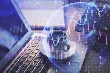 Double exposure of chart and financial info and work space with computer background. Concept of international online trading.