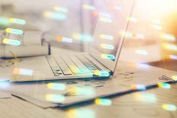 Double exposure of laptop computer and technology theme hologram. Concept of freelance work.