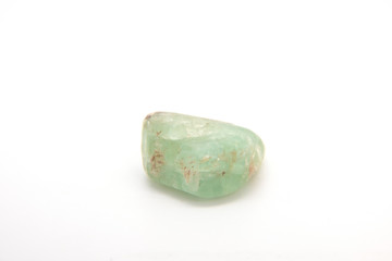 Natural mineral from geological collection - raw green Beryl crystal on white background.