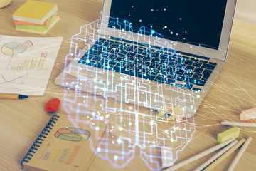 Multi exposure of work table with computer and brain hologram. Brainstorm concept.