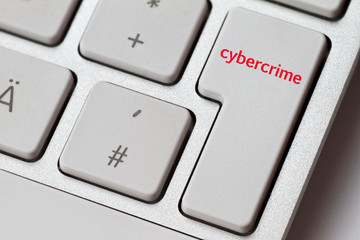 cybercrime as a word on the enter key of an aluminum keyboard