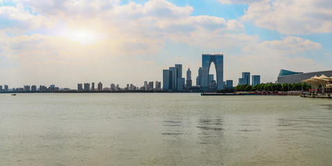 Obraz premium Beautiful city skyline and tranquil lake in Suzhou at sunset