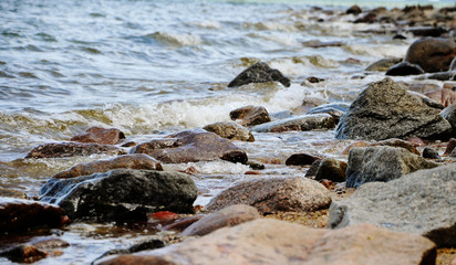 sea shore, stones on the shore, close-up, blurred background