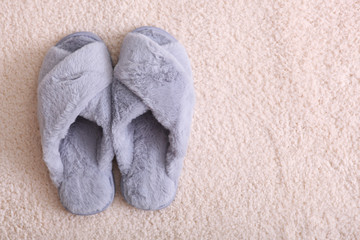Fototapeta na wymiar Women's slippers on a light background.