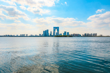 Beautiful city skyline and tranquil lake in Suzhou at sunset