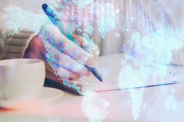 Forex chart displayed on woman's hand taking notes background. Concept of research. Double exposure