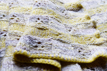 Abstract yellow wool knitting fabric background. Spring colors texture background from merino knitted blanket, scandinavian minimalism backdrop top view.