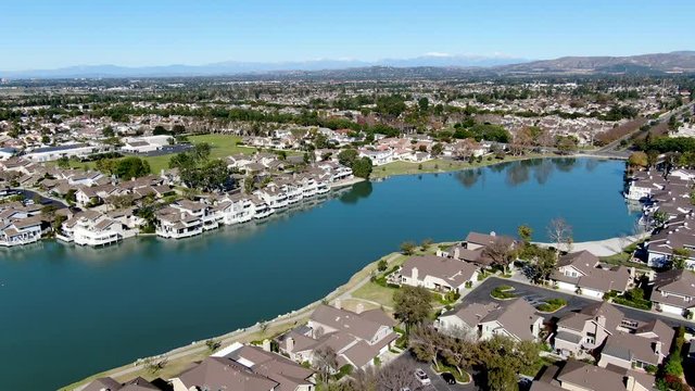 Aerial view of North Lake surrounded by residential neighborhood during blue sky day in Irvine, Orange County, USA