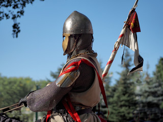 knight in armor close-up on a horse and with a spear