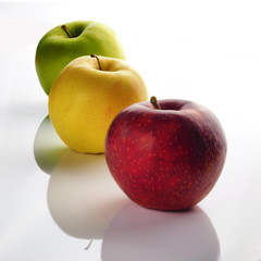 Red, green and yellow apple on a white background