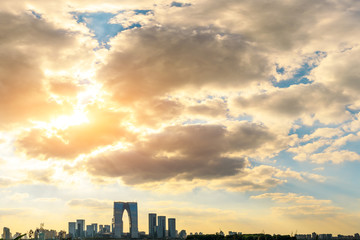 Fototapeta premium Beautiful city skyline and tranquil lake in Suzhou at sunset