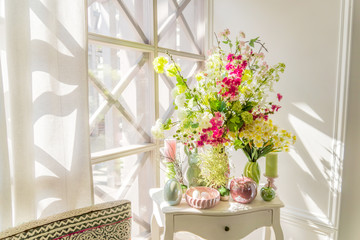 Easter interior decoration. Beatuful composition with candles. eggs, rabbit, apples and blooming flowers.