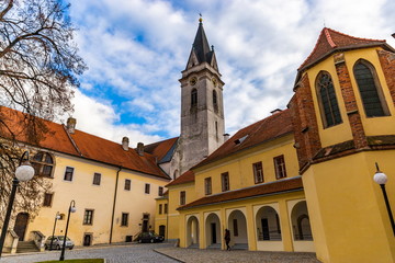 Fototapeta na wymiar Courtyard Church of St. Giles and the Virgin Mary Royal in the old town of Trebon, Czech Republic.