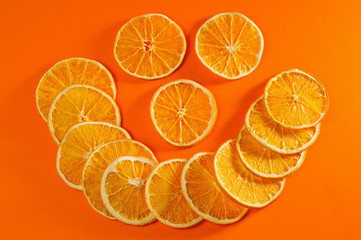 Dried orange chips, eco-friendly, vegetarian shot large on a bright orange background