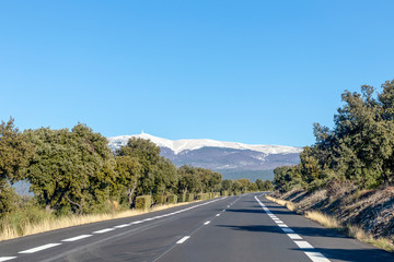 Empty asphalt road to Mont Ventoux, through Provence countryside at sunny winter day in southern France