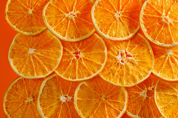 Dried orange chips, eco-friendly, vegetarian shot large on a bright orange background