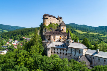 Fototapeta na wymiar Orava castle - Oravsky Hrad in Oravsky Podzamok in Slovakia. Medieval stronghold on extremely high and steep cliff. Aerial view