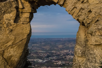 Fototapeta na wymiar View through the natural rock frame on San Marino landscape - Image