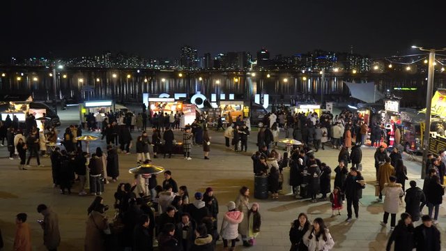 People eating food at Christmas Market in Seoul 2019, Yeouido district, top view, night lights, reflections in Han river, p2