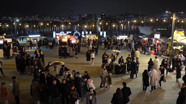 People eating food at Christmas Market in Seoul 2019, Yeouido district, top view, night lights, reflections in Han river,  p3
