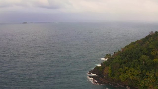 Beautiful aerial orbit view across seascape to reveal tropical Panama island jungle coastal wilderness.