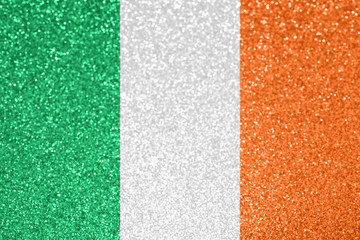 Fototapeta premium Ireland national flag. St Patrick's day, festive holiday background. Defocused glitter texture