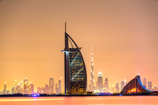 DUBAI, UAE - JANUARY 20, 2016: Burj Al Arab is a luxury 5 star hotel built on an artificial island in front of Jumeirah beach, with the city skyline.